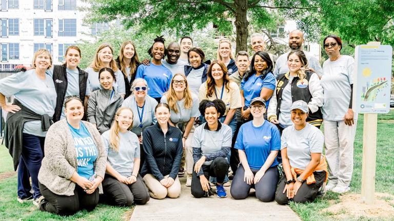 Volunteers, staff from United Way Worldwide, United Way of the National Capital Area, and partners from the City of Alexandria gather in group photo