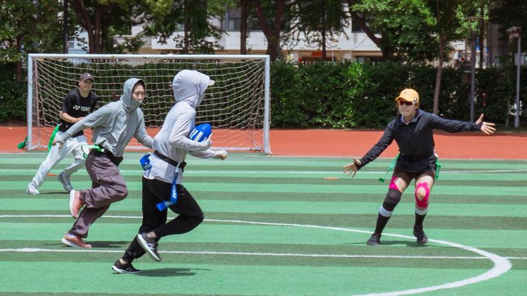Four young athletes in China play flag football through a United Way Worldwide initative with the NFL promoting youth fitness