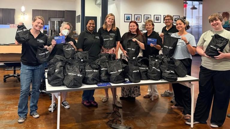 Volunteers at the United Way Resiliency Center in new Orleans hold up emergency kits