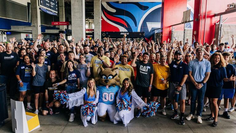Group photo of United Way of Greater Nashville Stuff the Buss event at Nissan Stadium