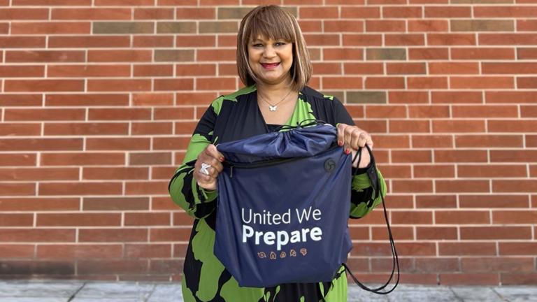 Arnita DeShields holding a United We Prepare emergency kit