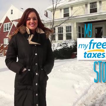 young woman in front of a house with my free taxes banner on the side