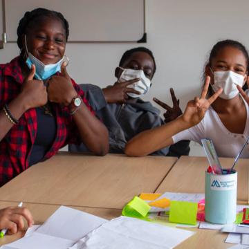 young people with face masks around table