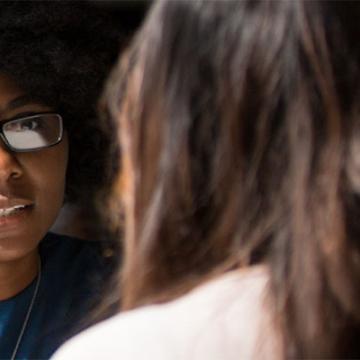 Two women facing each other talking