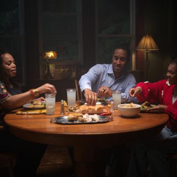 Family at dinner table eating