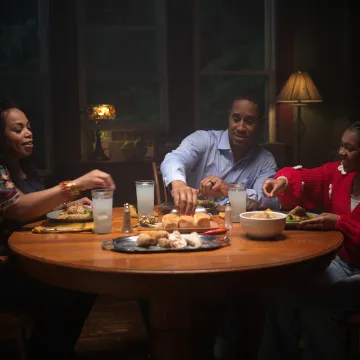 Family at dinner table eating