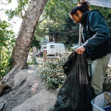 Man picking up debris after wildfire