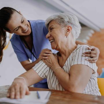 Nurse with elderly patient at a table