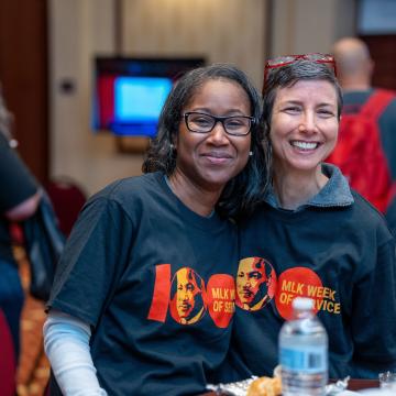 Two volunteers in MLK shirts