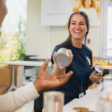 Woman at a food pantry sorting cans