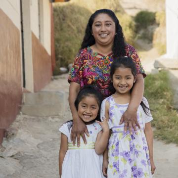 Woman standing outside with her two children