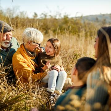 Family sitting in a field of grain