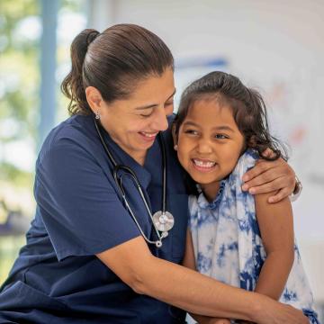 Nurse embracing a small child