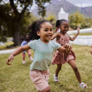 Children running in through grass