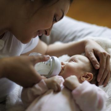 Mother giving a bottle to a newborn baby