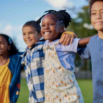 Children standing happily outside together