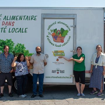 United Way representatives with food storage container
