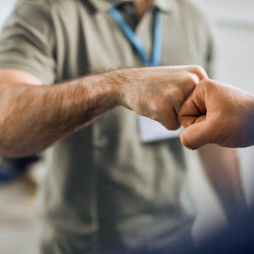 A fist bump shared between two people