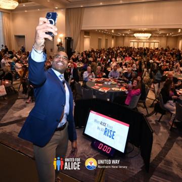 A speaker taking a picture with an audience