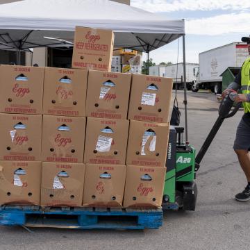 Man pushing a pallet of food at a United Way event
