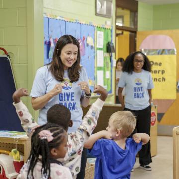 Children in a classroom with United Way adults