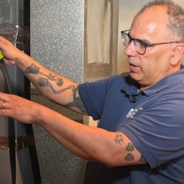 A professional evaluating weatherization of appliances