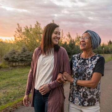 Two women walking down a rural road