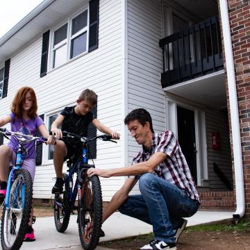 Jason helps his kids ride their bikes
