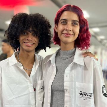 Two young people wearing white coats