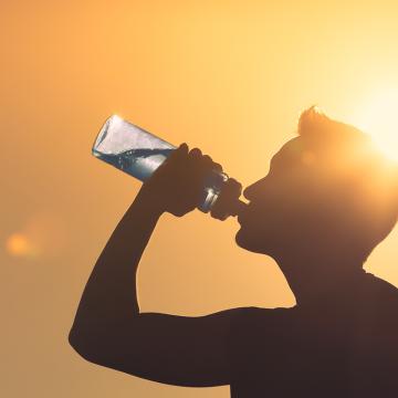 Man drinking water in sun