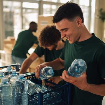 Man putting water bottles in kit