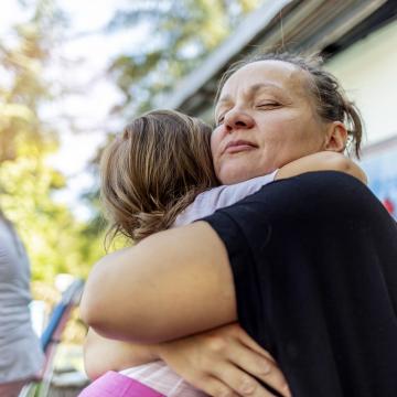 Mom and daughter embracing after tragedy