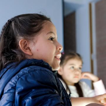 Girls Listening to a Teacher