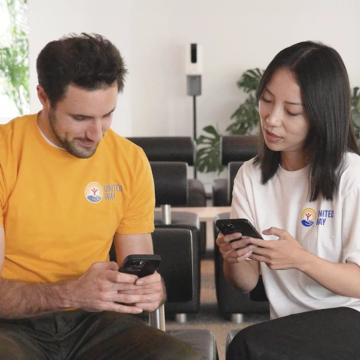Two people exchanging information while looking at their phones