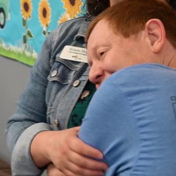 Young person hugging Kristin Hegji
