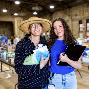A United Way worker and a woman holding water bottles