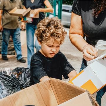 A young child holding a box