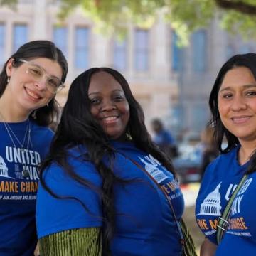 Three recipients of the scholarships smiling in front of the Texas Capitol in Austin
