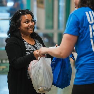 Woman Receiving Bags of Food