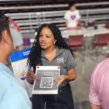 A disaster workshop leader shares a QR code to download a preparedness kit.