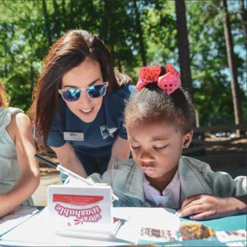 An adult and two children experience United Way's screen-free Born Learning Trail in Richmond, Va. 