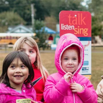Kids wearing winter jackets play at a Born Learning Trail in Richmond, Va.