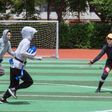 Four young athletes in China play flag football through a United Way Worldwide initative with the NFL promoting youth fitness