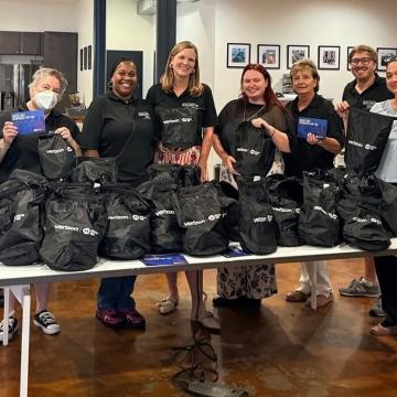 Volunteers at the United Way Resiliency Center in new Orleans hold up emergency kits
