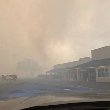 Wildfires burn by a shopping center in Valdosta, Georgia