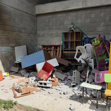 An early childhood classroom with broken desks in the aftermath of the earthquake in Colombia