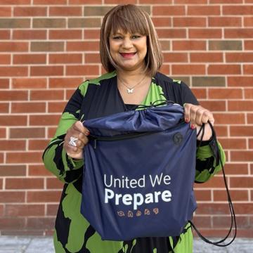 Arnita DeShields holding a United We Prepare emergency kit