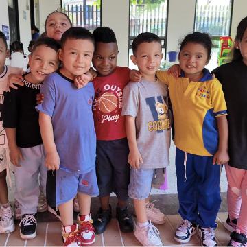 A group of young schoolchildren in Colombia standing together and smiling at the camera