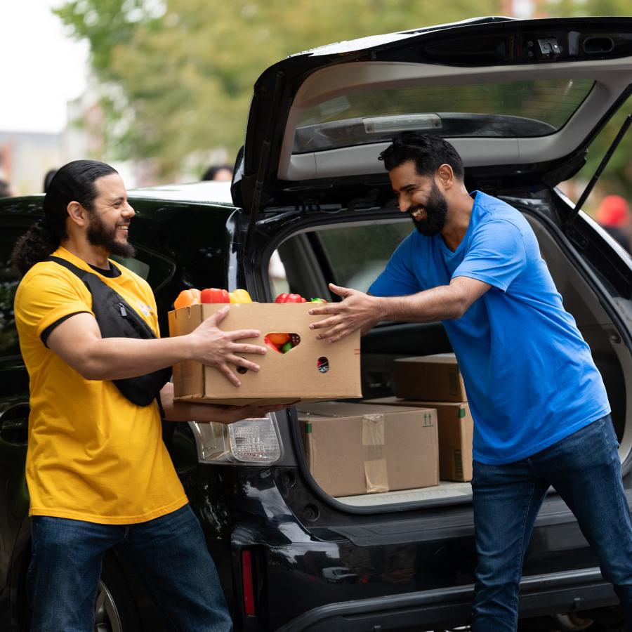 Two people handing food to each other