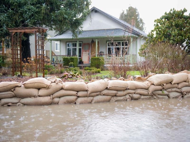 Sandbags in front of a house prevent flooding from impacting the home